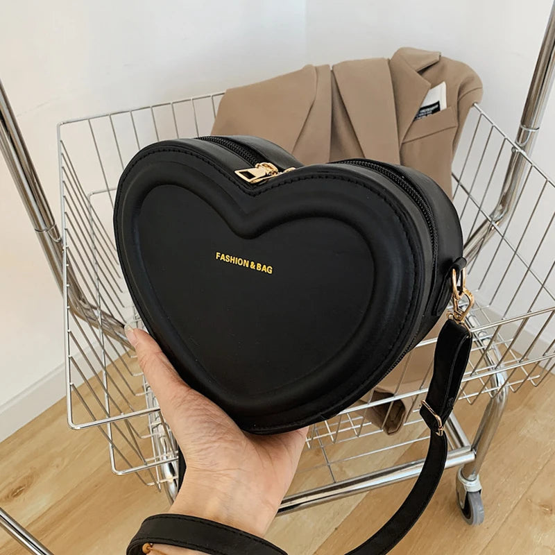 Heart-Shaped Crossbody Bag: A fashionable, heart-shaped PU leather crossbody bag for women, perfect for making a style statement.