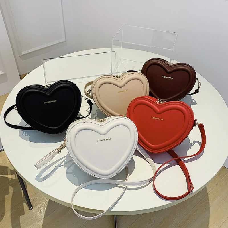 Heart-Shaped Crossbody Bag: A fashionable, heart-shaped PU leather crossbody bag for women, perfect for making a style statement.