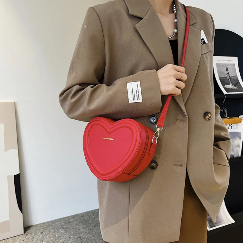 Heart-Shaped Crossbody Bag: A fashionable, heart-shaped PU leather crossbody bag for women, perfect for making a style statement.