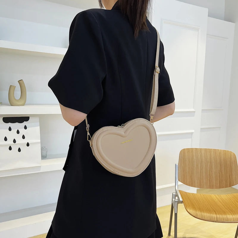 Heart-Shaped Crossbody Bag: A fashionable, heart-shaped PU leather crossbody bag for women, perfect for making a style statement.